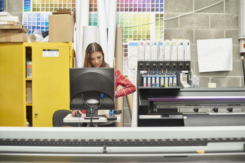 a person working on a digital printing machine