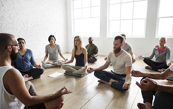 A group of people doing a guided meditation.