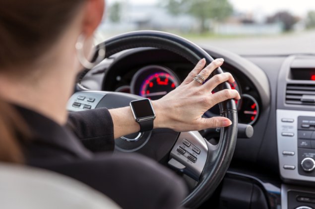 woman driving wearing smart watch