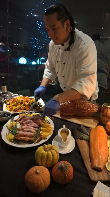 Carving the Piallago smoked ham, with hot rock salmon in the foreground