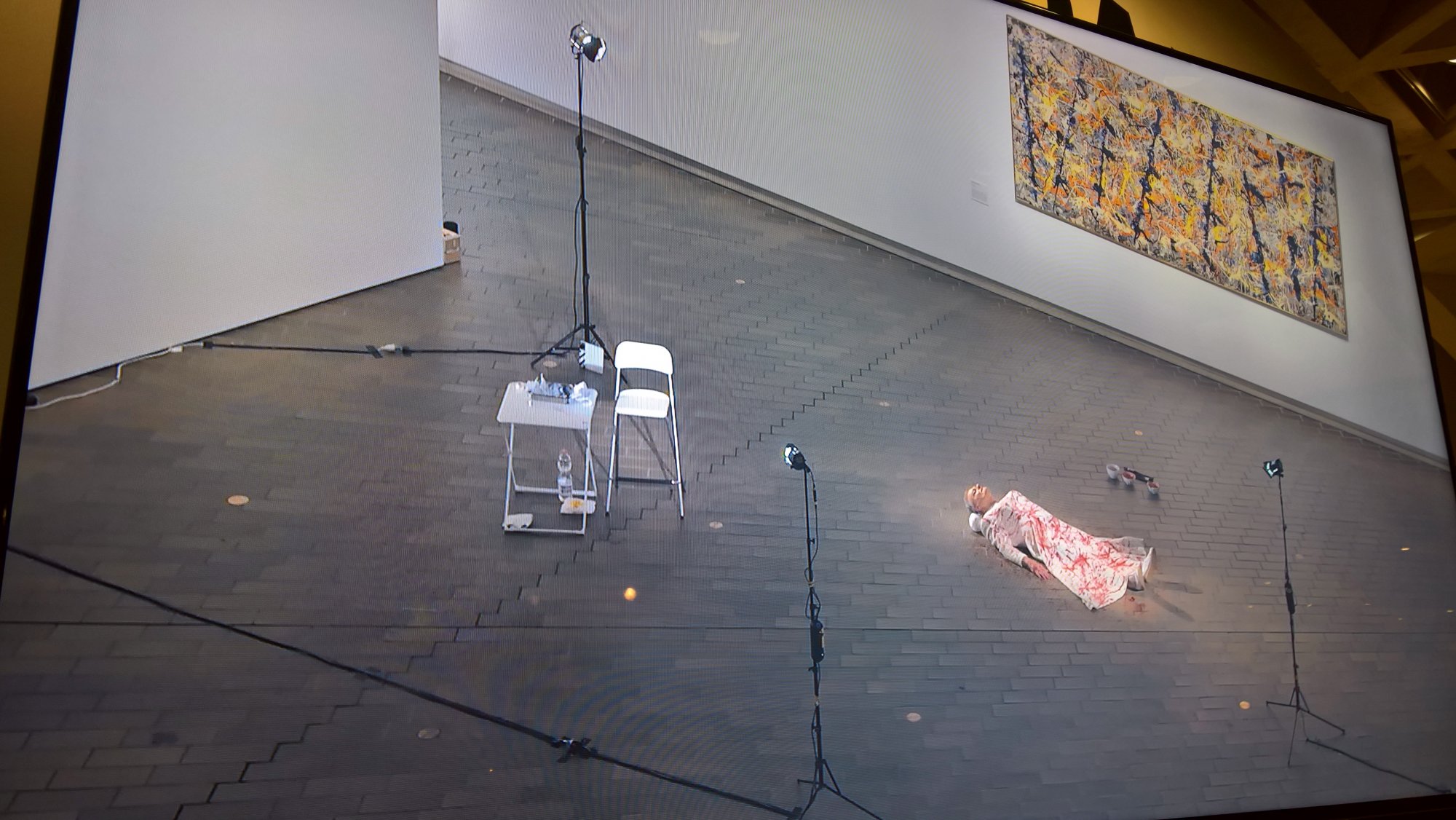 TV shot of Mike Parr lying on the floor covered in blood