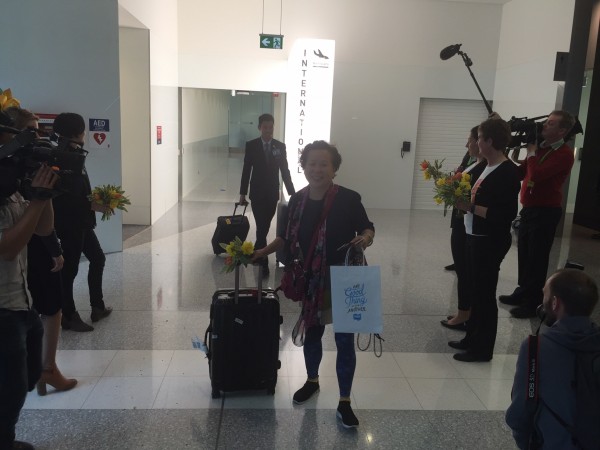 A happy traveller arrives in Canberra from Singapore on the first direct flight.