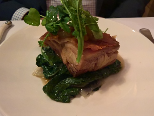 Roast suckling pig with bitter greens