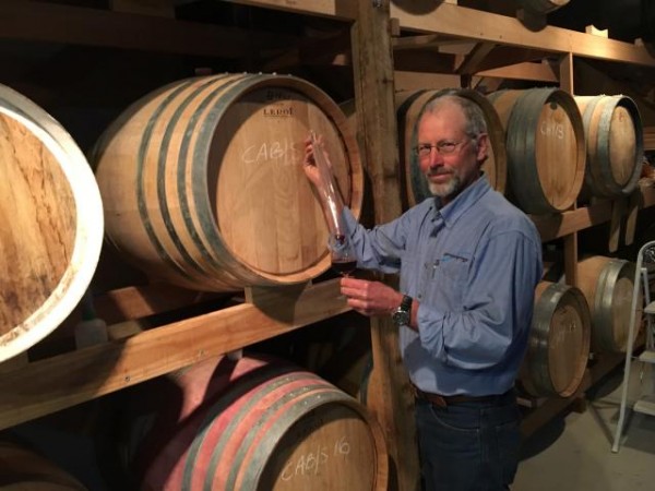 Danny Hansen samples wine in his straw bale cellar. Photo: John Thistleton