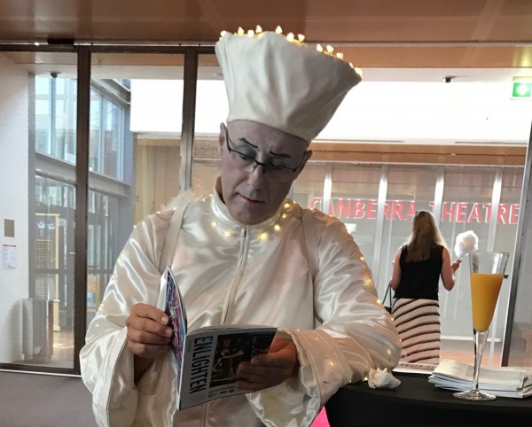 An angel reads the program for Enlighten 2017. Photo: Charlotte Harper