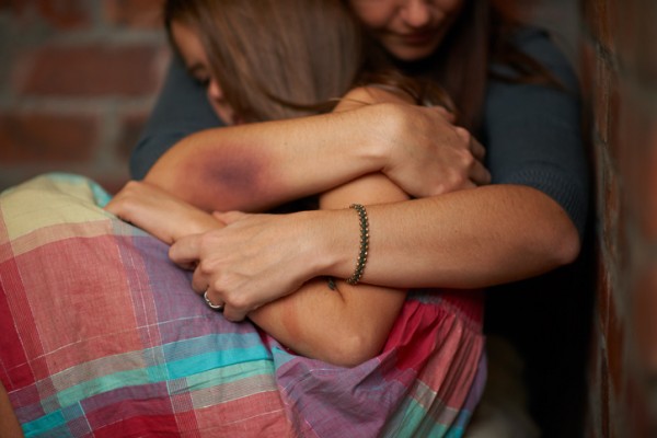 injured woman holds child