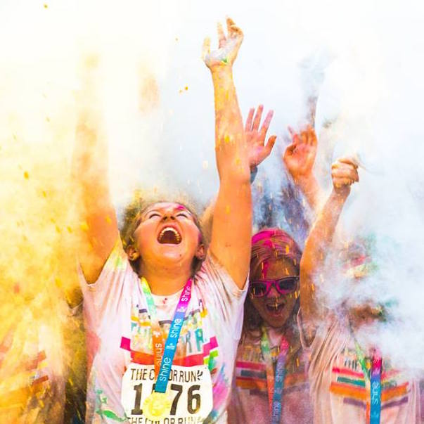 Runners being sprayed with colour