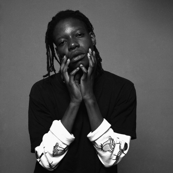 Black and white photo of young man holding his face