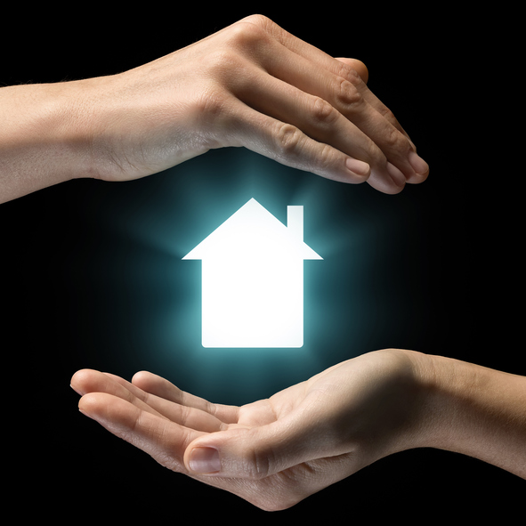 Isolated image of two hands on black background. House icon in the center, as a symbol of sale, rent, insurance and protection of real estate. Concept of sale, rent, insurance and protection of real estate.