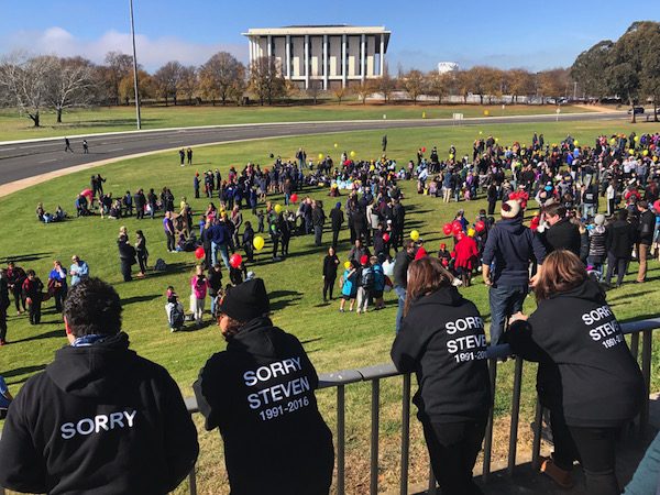 Supporters of Steven Freeman look on as participants prepare to walk back over the bridge. 