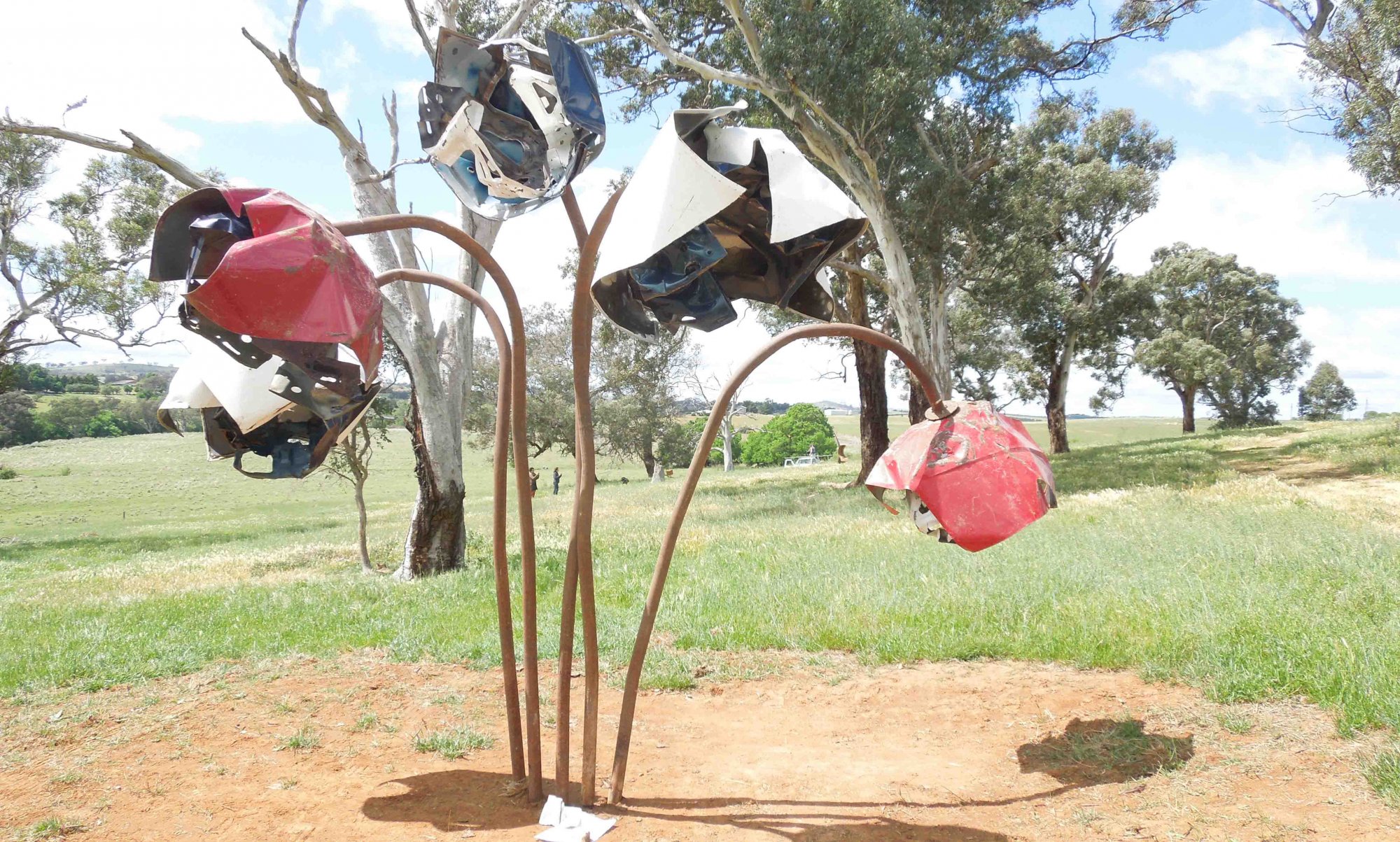 Sculpture with message flowers on Barton Highway