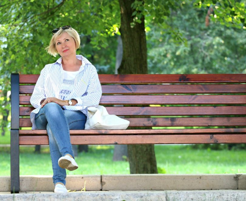 Woman sitting on park bench, thinking.