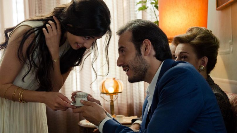 woman offering cup of tea to man