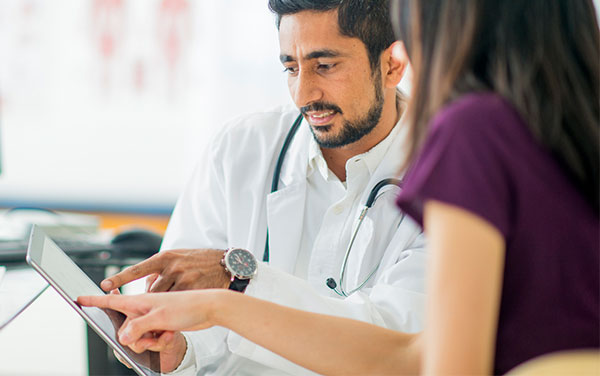 doctor reading an electronic tablet