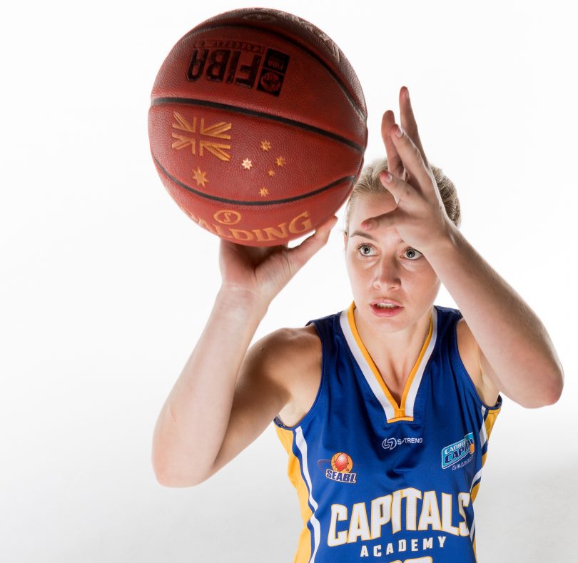 woman playing basketball.