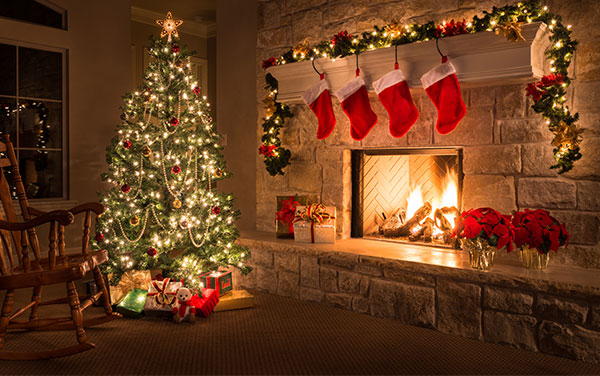 christmas tree by a fireplace