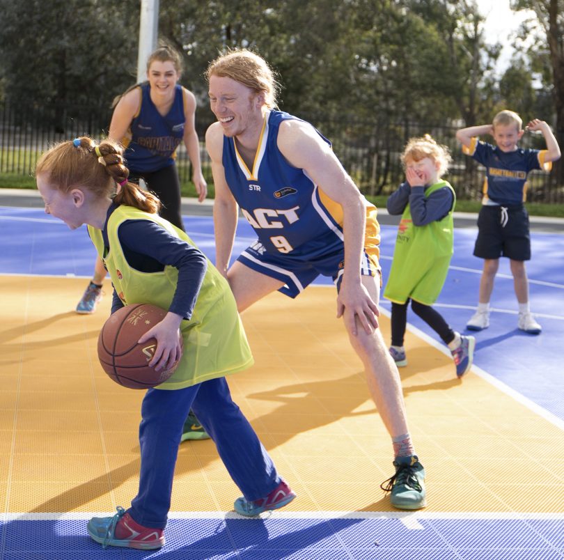 Reece Kaye and Chloe Tugliach play half-court hoops with some campers / Photo by Rosevear Photography.