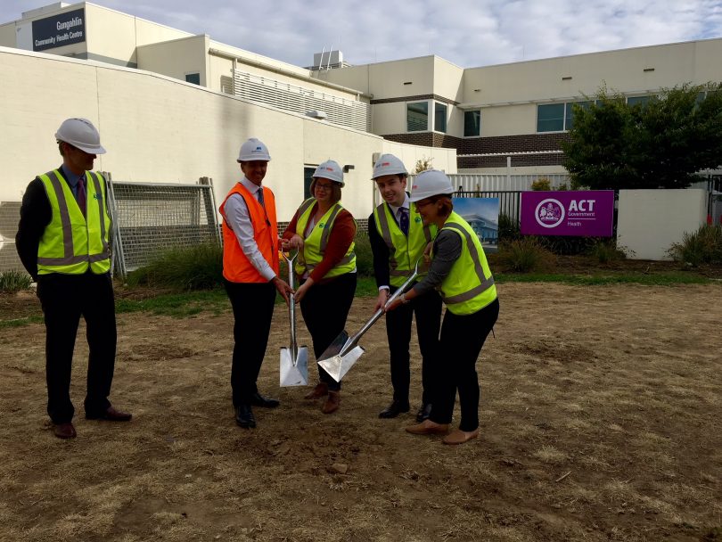 Minister Fitzharris, right, turns the first sod at the site of the Gungahlin Walk-in Centre. Photo: Supplied.