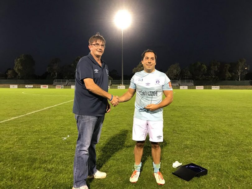 Cam Reinhart receiving a plaque commemorating his 200 games for Belconnen United two seasons ago. Photo: Supplied by Belconnen United.