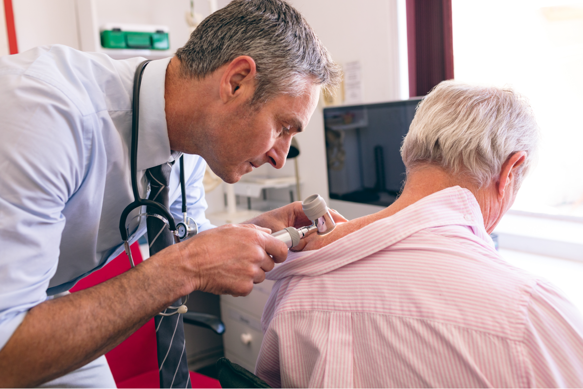 dermatologist examining a patient's skin