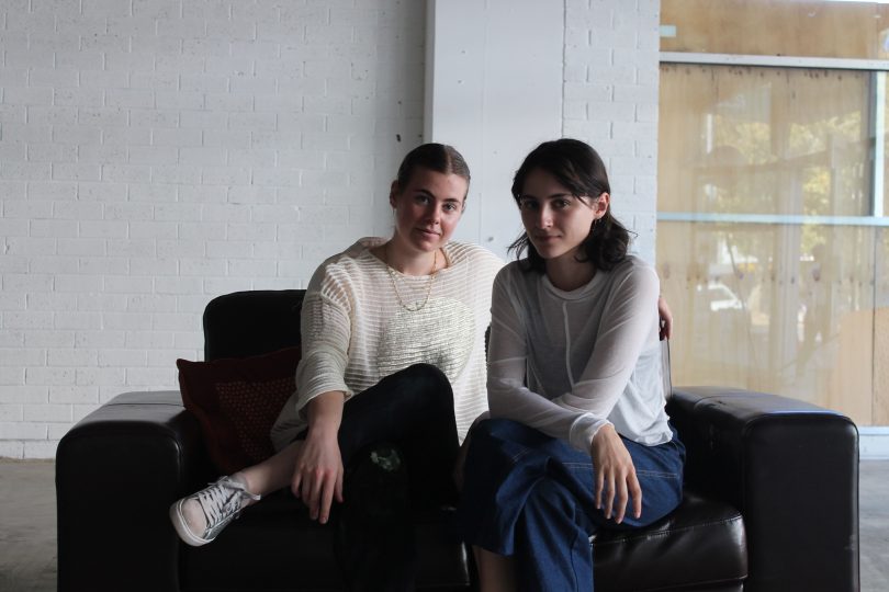 Photograph of Tegan Garnett and Christina Held sitting on a couch