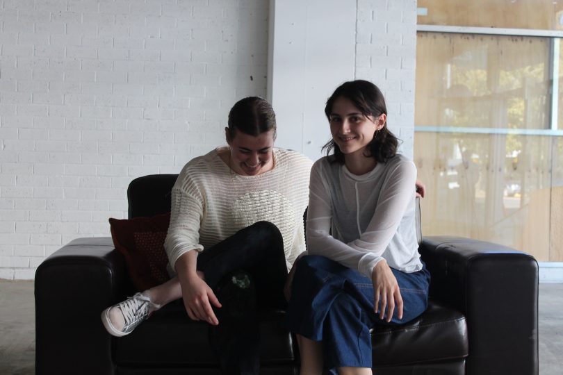 Photograph of Tegan Garnett and Christina Held sitting on a couch