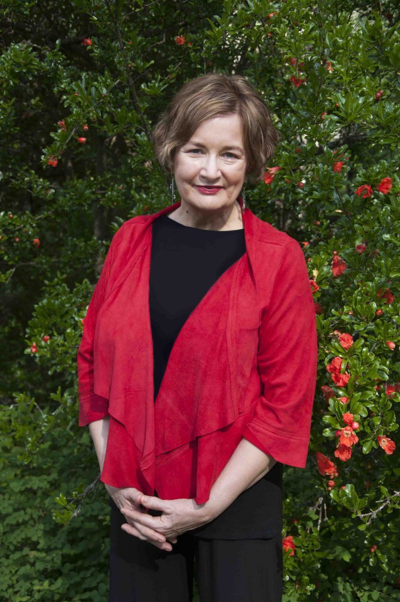 Photograph of Jackie French in front of greenery