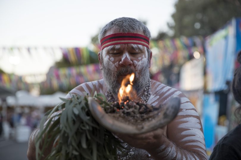 Indigenous man holding smoking eucalyptus