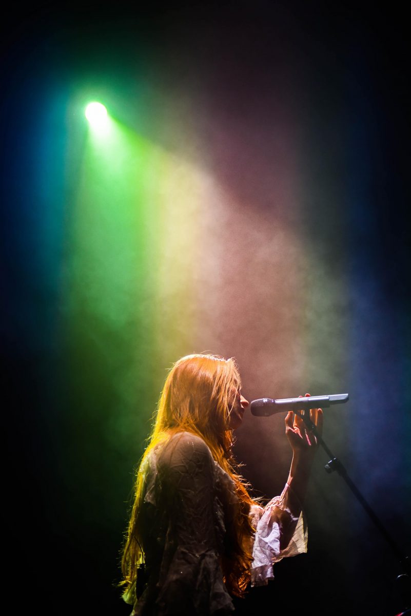 Photograph of Vera Blue performing in rainbow light