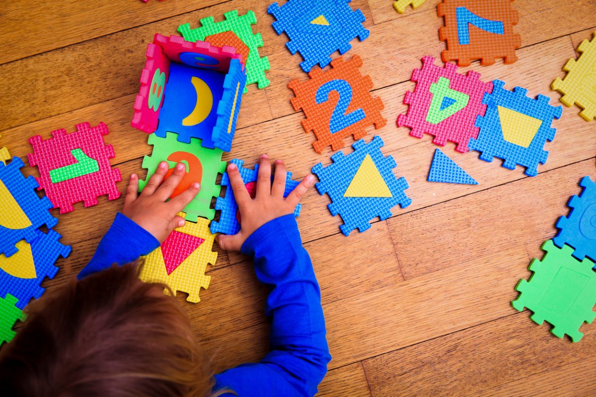 child playing with floor puzzle