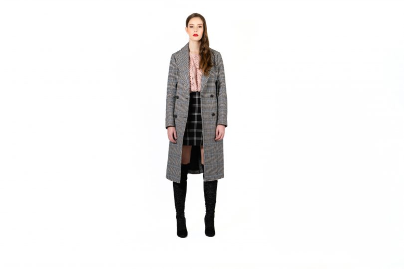 Model wearing check over coat