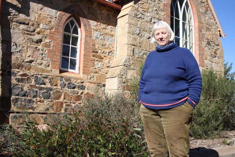 Australian native plant enthusiast Jenny Ashwell, outside the church she converted into a home which is surrounded by her native garden. Photo: Supplied.