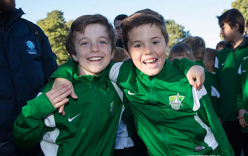 Two junior soccer players smiling