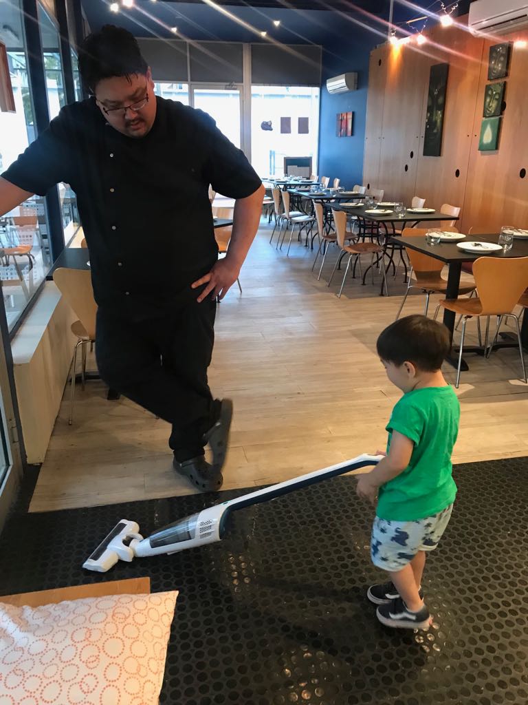 Chef Nei Rattanakosol teaching the next generation, his son, about the restaurant business. Photo: Supplied.