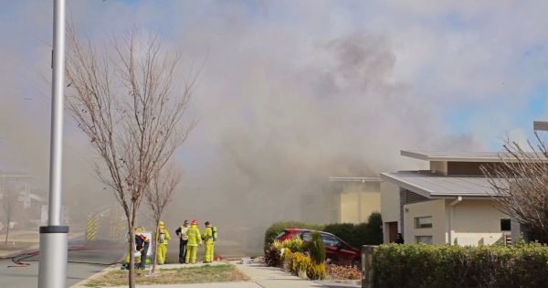 Woman and child hospitalised after fire tears through Crace home