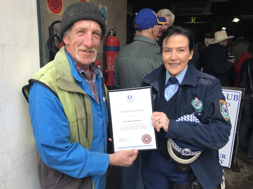 Neville Marsden from the NSW Ambulance Service presenting Murray with a certificate of appreciation for 50 years of service.