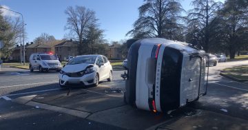Woman taken to hospital after car rolls on Ainslie Avenue