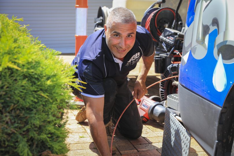 plumber looking at blocked drain