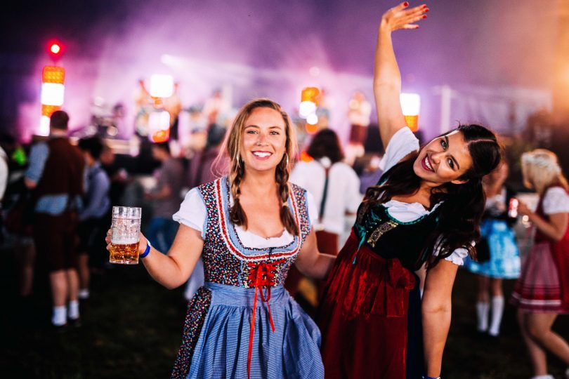 People celebrating Oktoberfest and drinking beer