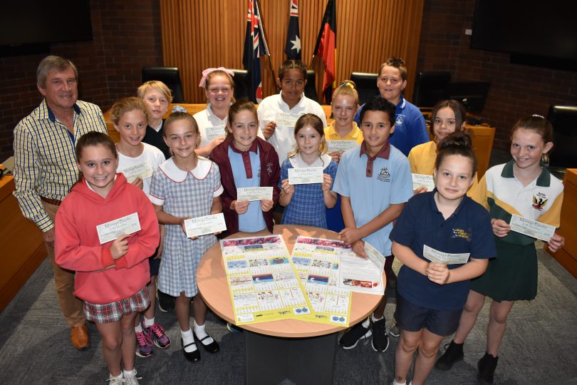 Eurobodalla Deputy Mayor Rob Pollock with students (back row) Tom Newbold of Narooma Public School, Stella Andrews of Broulee Public School, Shaniquah Thomas-Tighe of Batemans Bay Public School, Jackson West (representing Moruya Public School’s Maddie Johnston and Luke Amos), (middle row) Anwen Cowie of Central Tilba Public School, Millie Duncombe of Batemans Bay Public School, Rebeka Frialova of Sunshine Bay Public School, Amy white of Broulee Public School, Alexis Leth of St Bernard’s Primary School, Chelsea Wood of St Mary’s Primary School, Scarlet Leone of St Peter’s Anglican College, Harrison Katuke of St Mary’s Primary School, Marlie Elliott of Mogo Public School and Ella Norman of Bodalla Public School. Photo: ESC.