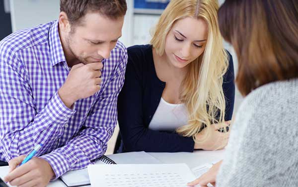 two people looking over a document