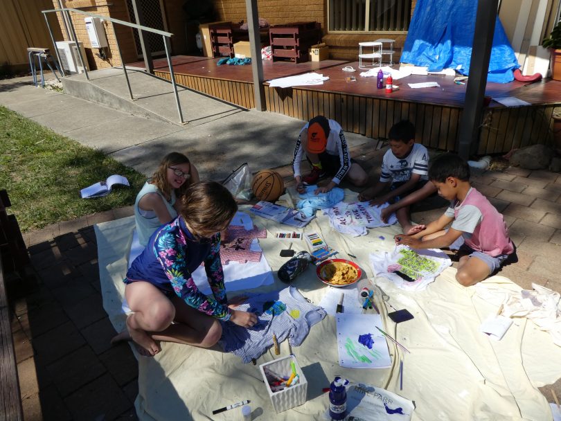 Ayo, Zaki, Nia and Iolo preparing posters for the rally.