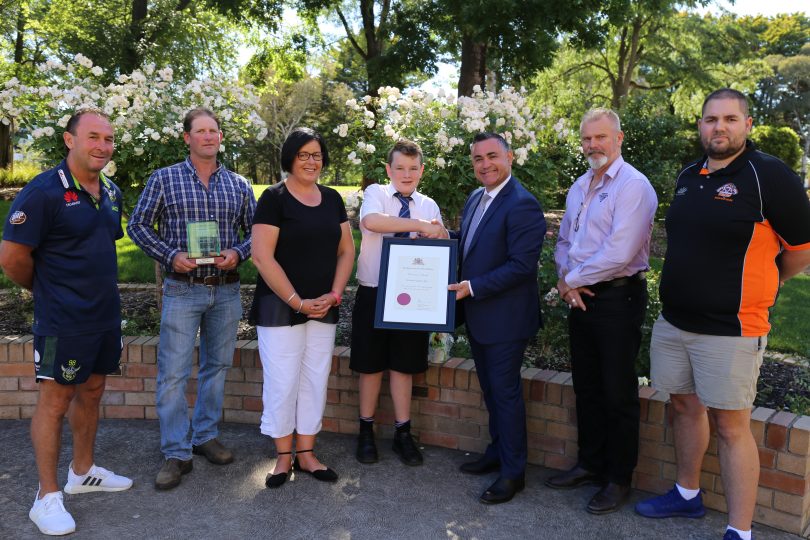 Member for Monaro John Barilaro joined Hudson, his family, friends and Ricky Stuart to present Hudson with the Premier’s Award for outstanding work in raising autism awareness. Photo: Supplied