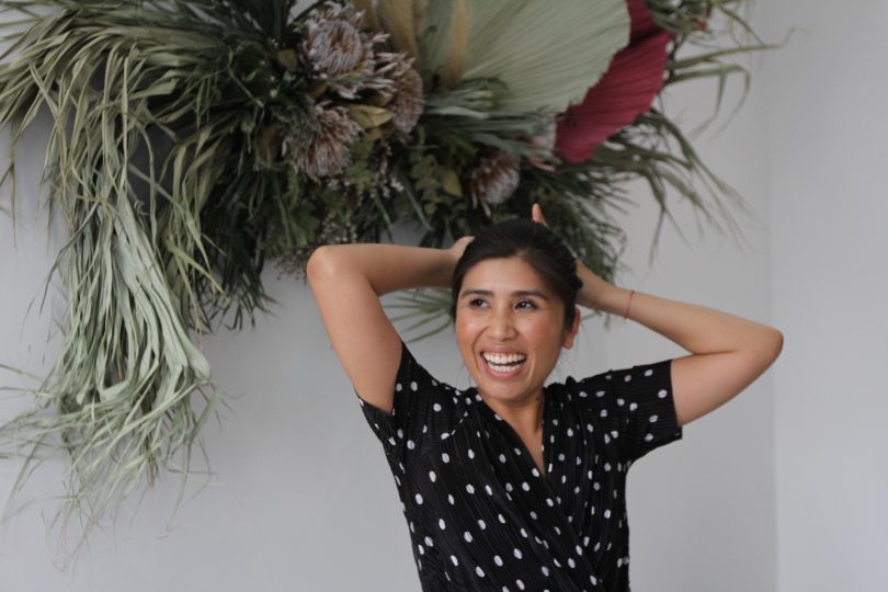 Soud's in her Midtown Prectinct studio with amazing wall floral arrangement by Barton Flower Bar.