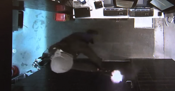 Police release CCTV footage of gun-wielding man robbing Hotel Queanbeyan