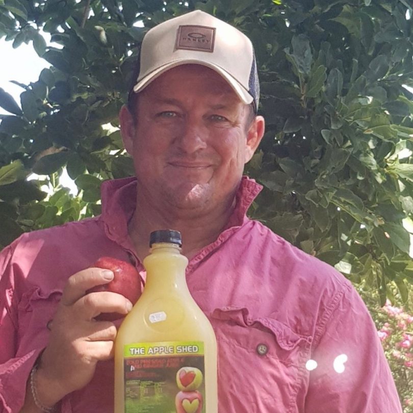 Southside Market owner Wayne Skein with his fresh apple juice.