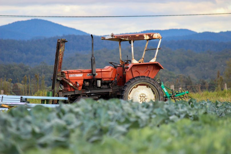 Tractor sitting in field on a farm.