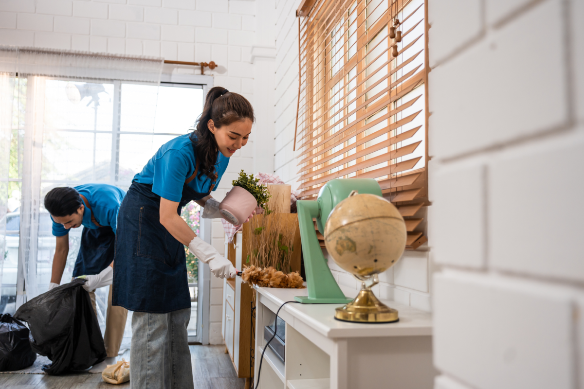 two people cleaning a house