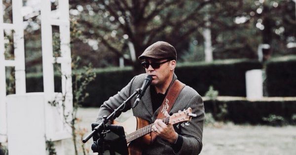 Armed with his guitar, Bill Olson set to soothe the crowd at Sunday Sessions