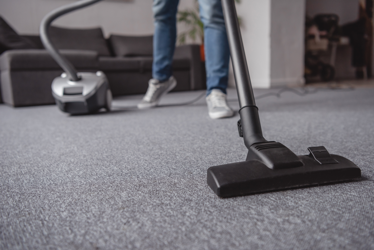 a person vacuuming carpet